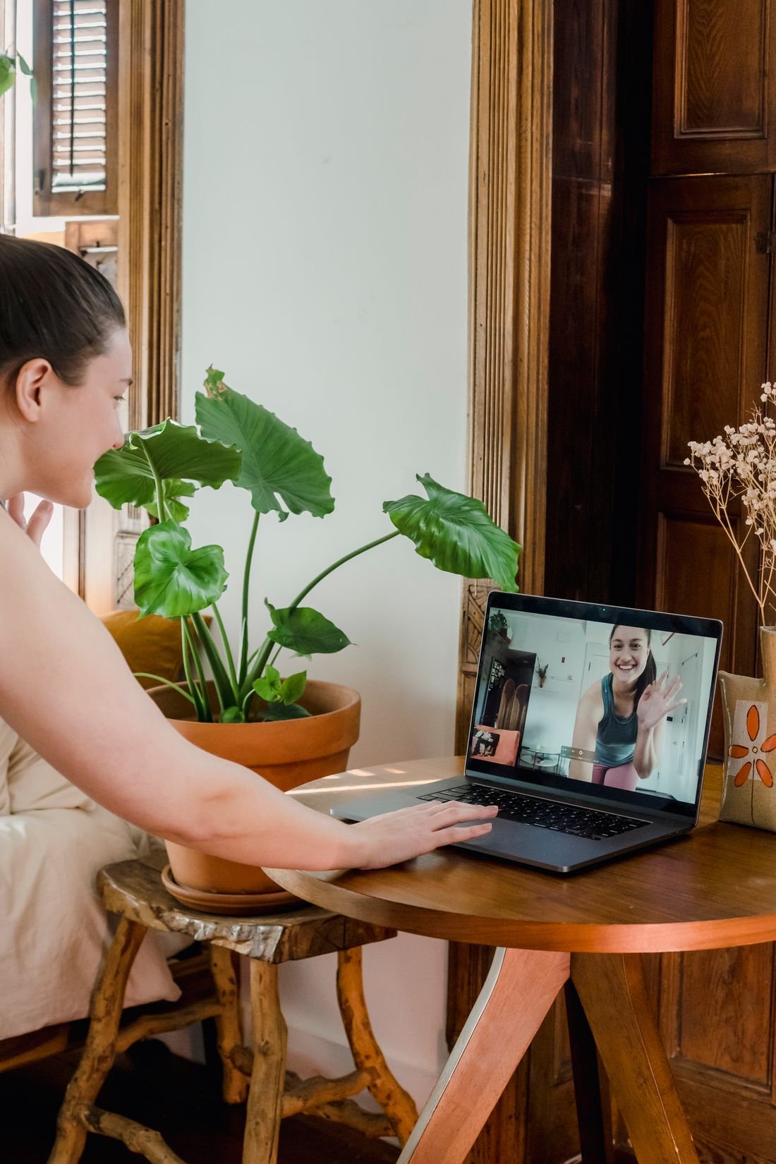 A student taking a counselling session on a laptop at home
